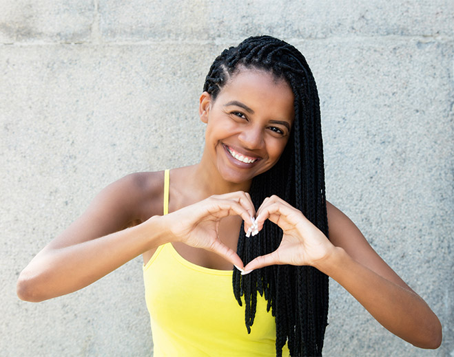 Woman forming heart with hands